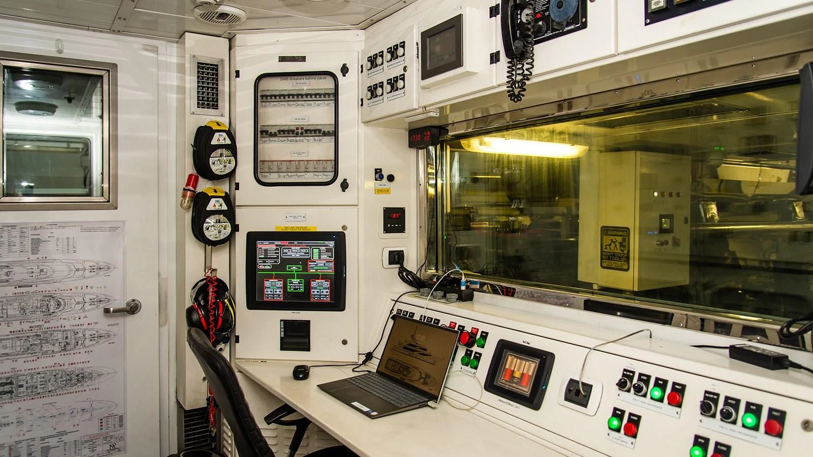 a room with a computer and a laptop on a table aboard ALI BABA Yacht for Sale