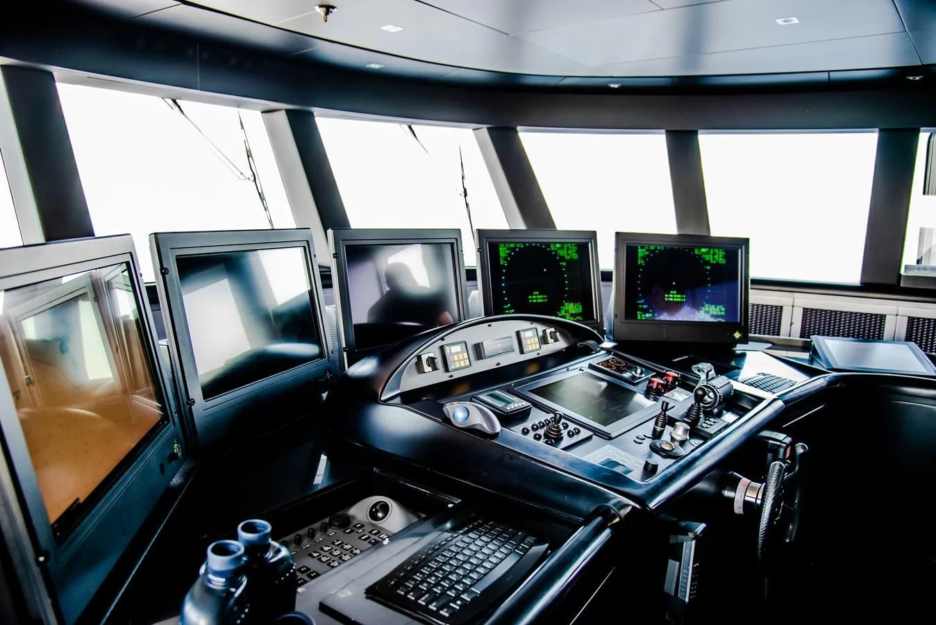 a control room with several monitors aboard ALI BABA Yacht for Sale