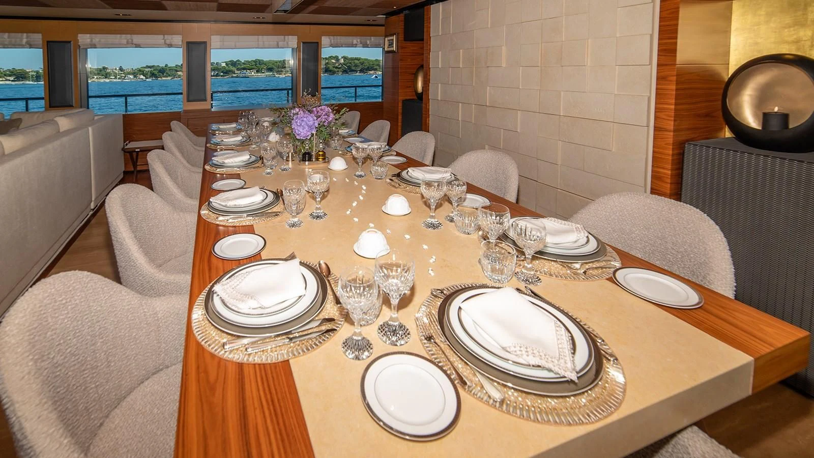 a table with plates and glasses on it aboard ALI BABA Yacht for Sale