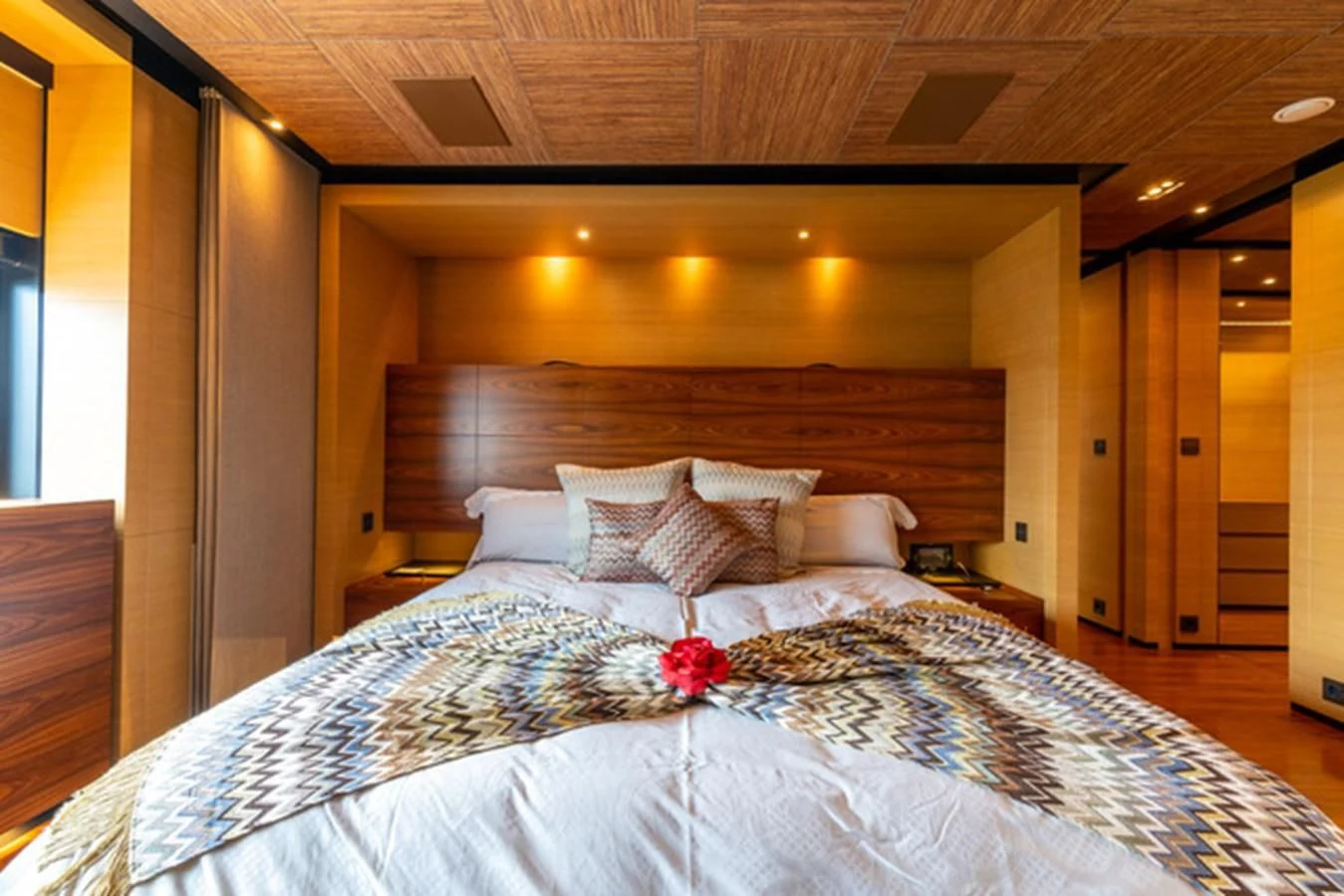 a bed with a flower on the bed aboard ALI BABA Yacht for Sale