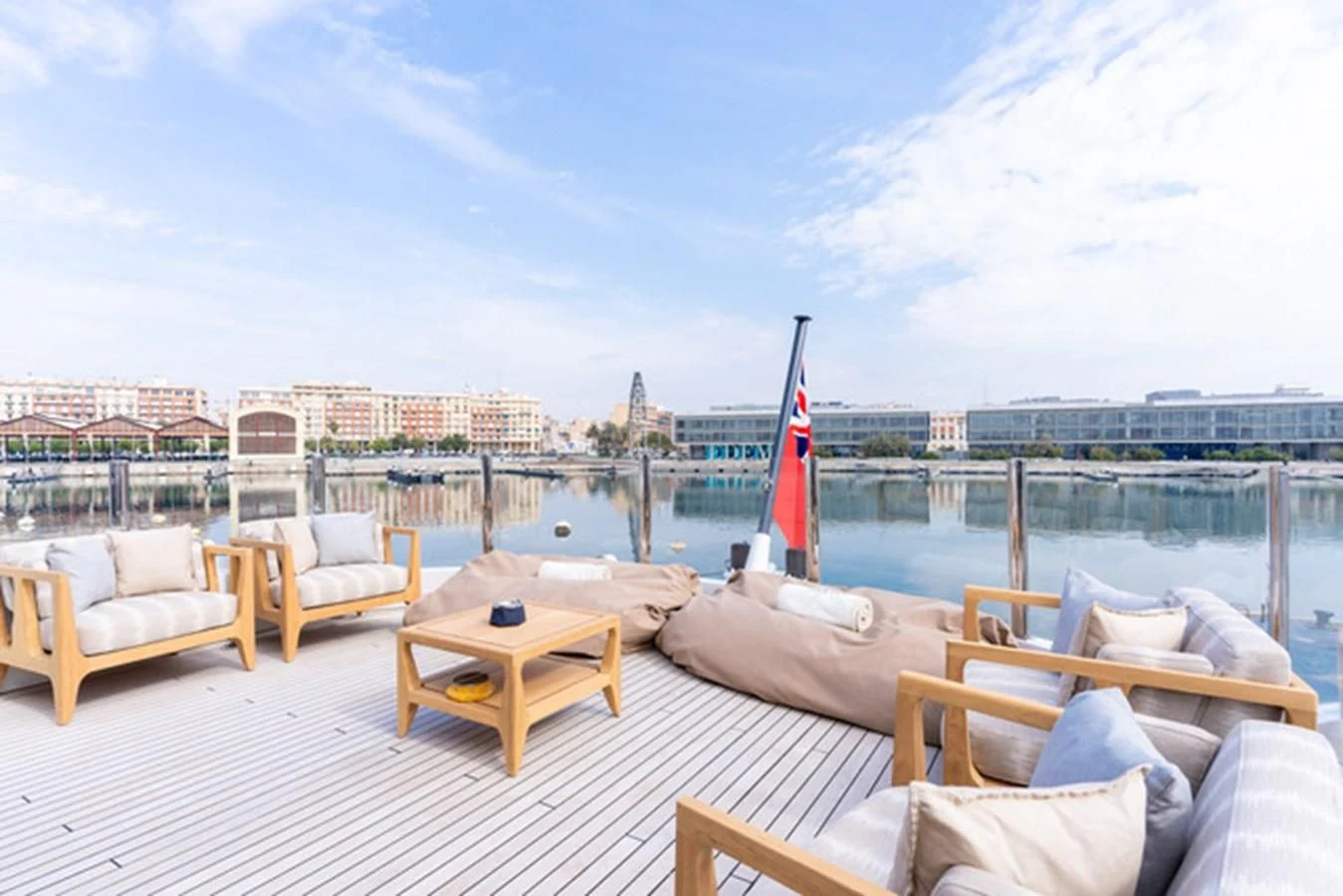 a deck with chairs and a boat on it aboard ALI BABA Yacht for Sale