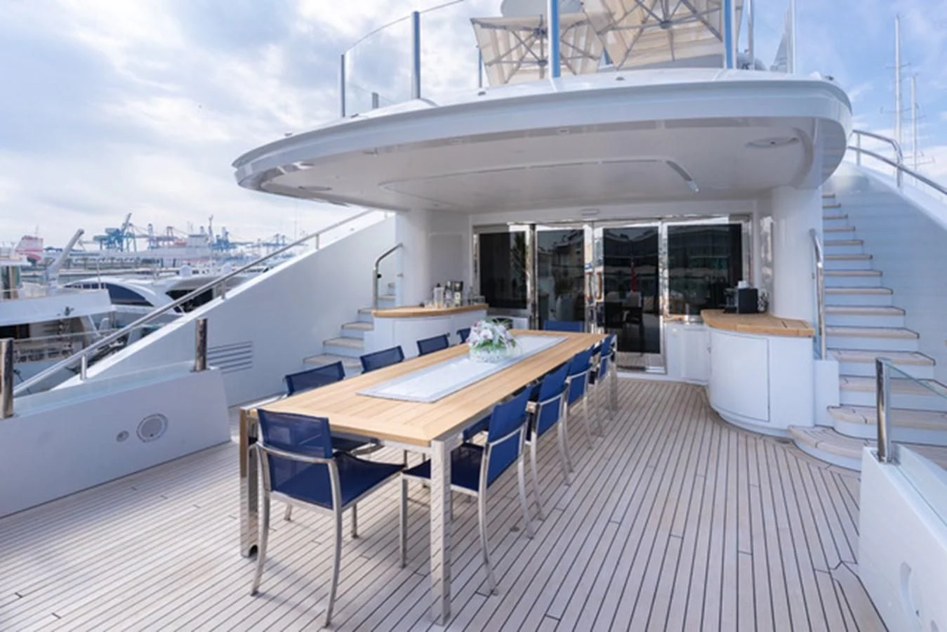 a large white building with a table and chairs aboard ALI BABA Yacht for Sale