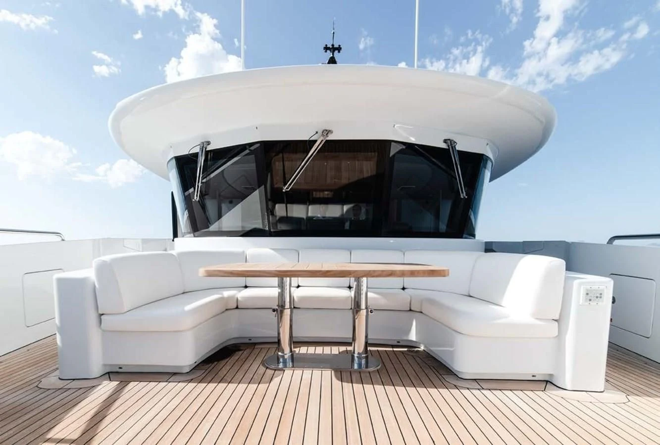 a white couch and a table aboard ALI BABA Yacht for Sale