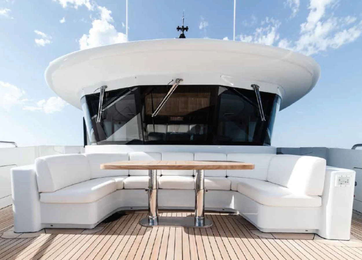 a white couch with a table in front of it aboard ALI BABA Yacht for Sale