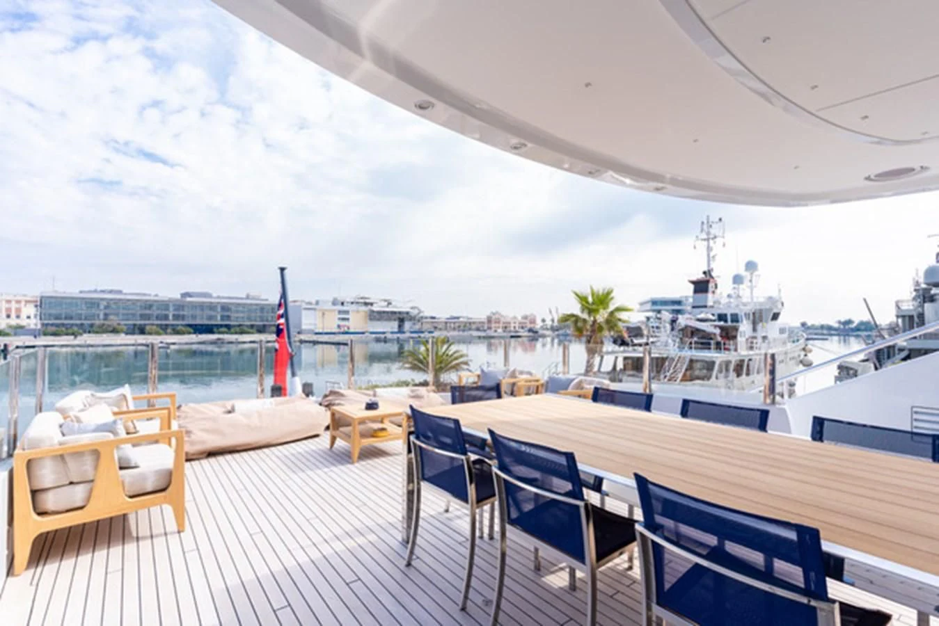 a deck with chairs and tables on it aboard ALI BABA Yacht for Sale