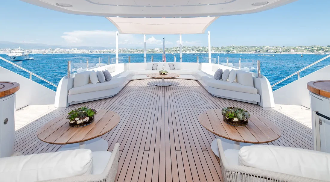 a table on a deck overlooking a body of water aboard ALI BABA Yacht for Sale