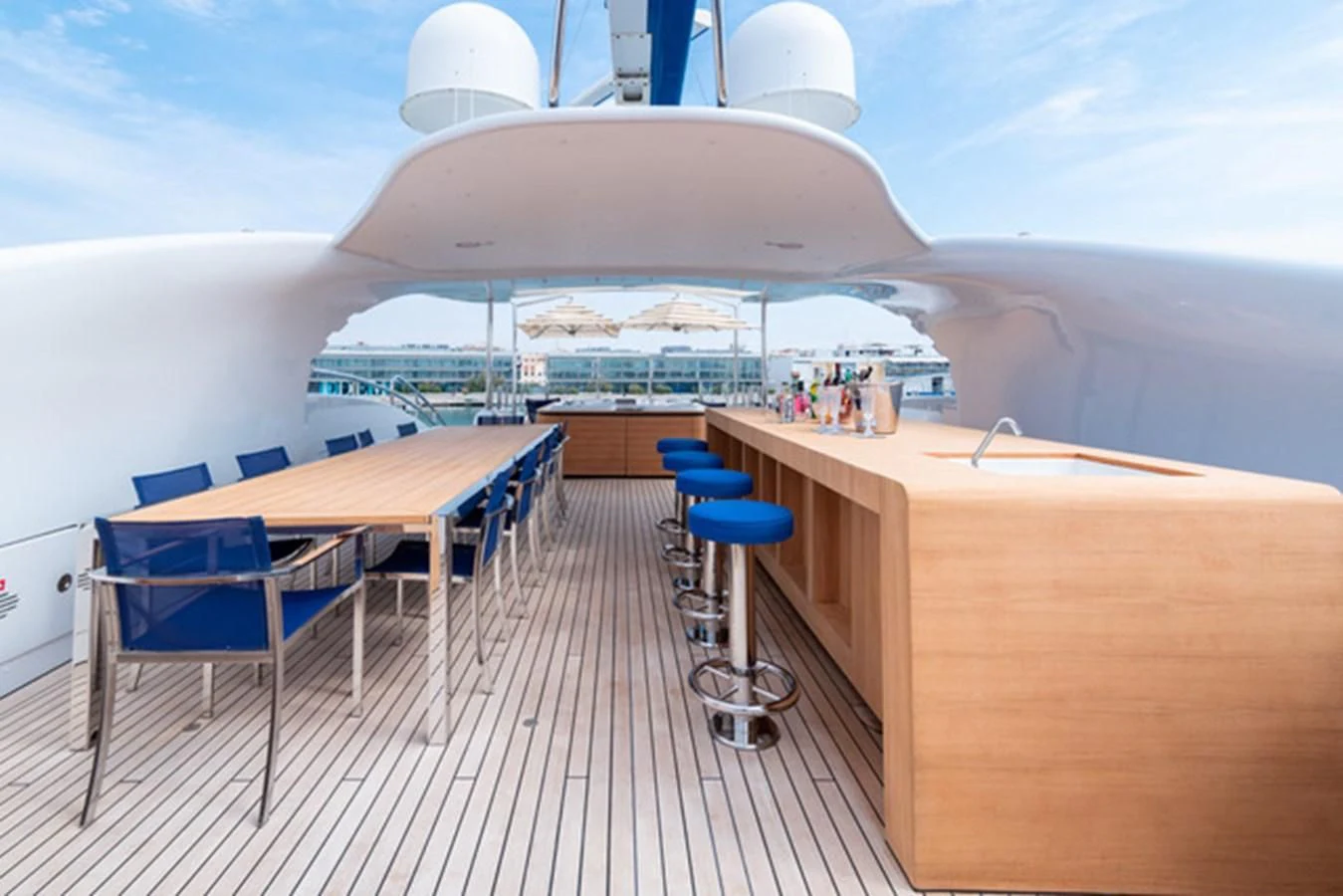 a deck with a table and chairs on it aboard ALI BABA Yacht for Sale
