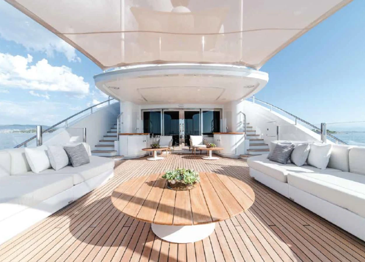 a large white lounge chair on a deck with a large white sofa and a large white sofa and aboard ALI BABA Yacht for Sale