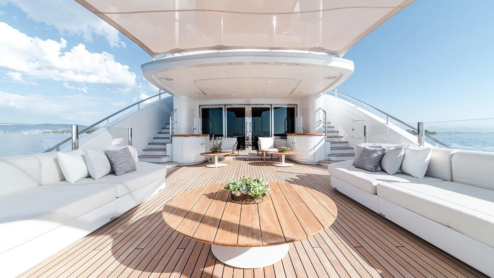 a room with a bed and a table and chairs aboard ALI BABA Yacht for Sale