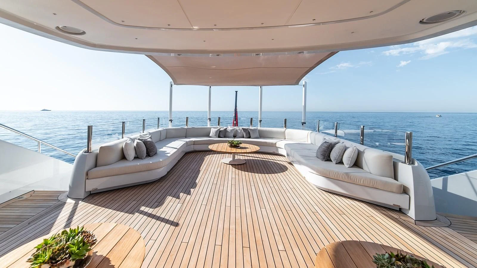 a large white lounge chair on a deck overlooking a large body of water aboard ALI BABA Yacht for Sale