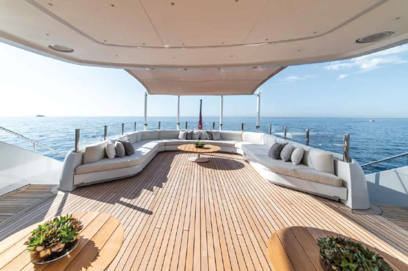 a large white lounge chair on a deck overlooking a large body of water aboard ALI BABA Yacht for Sale