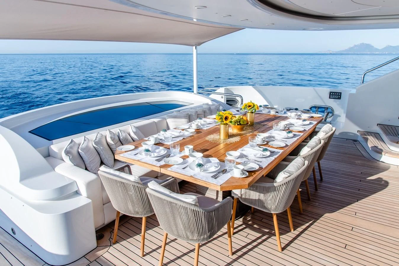 a table set for a dinner on a boat aboard ALI BABA Yacht for Sale