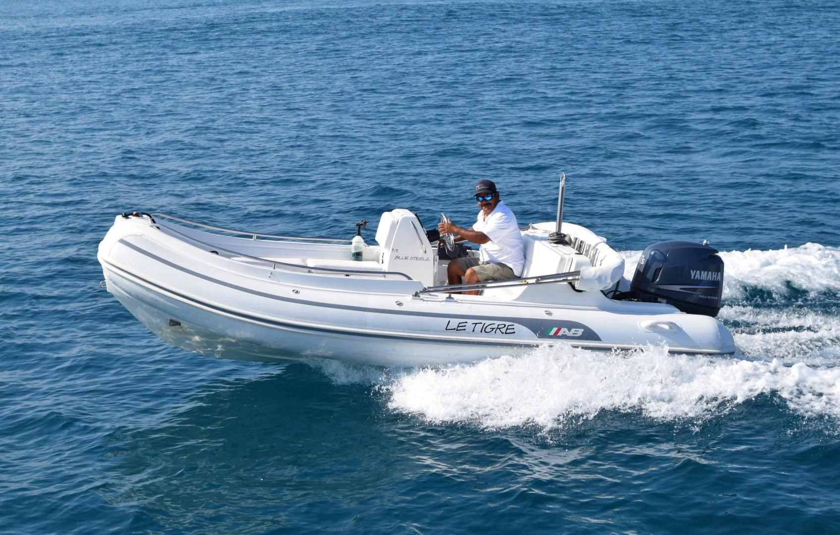 a man driving a boat aboard BLUE STEELE Yacht for Sale