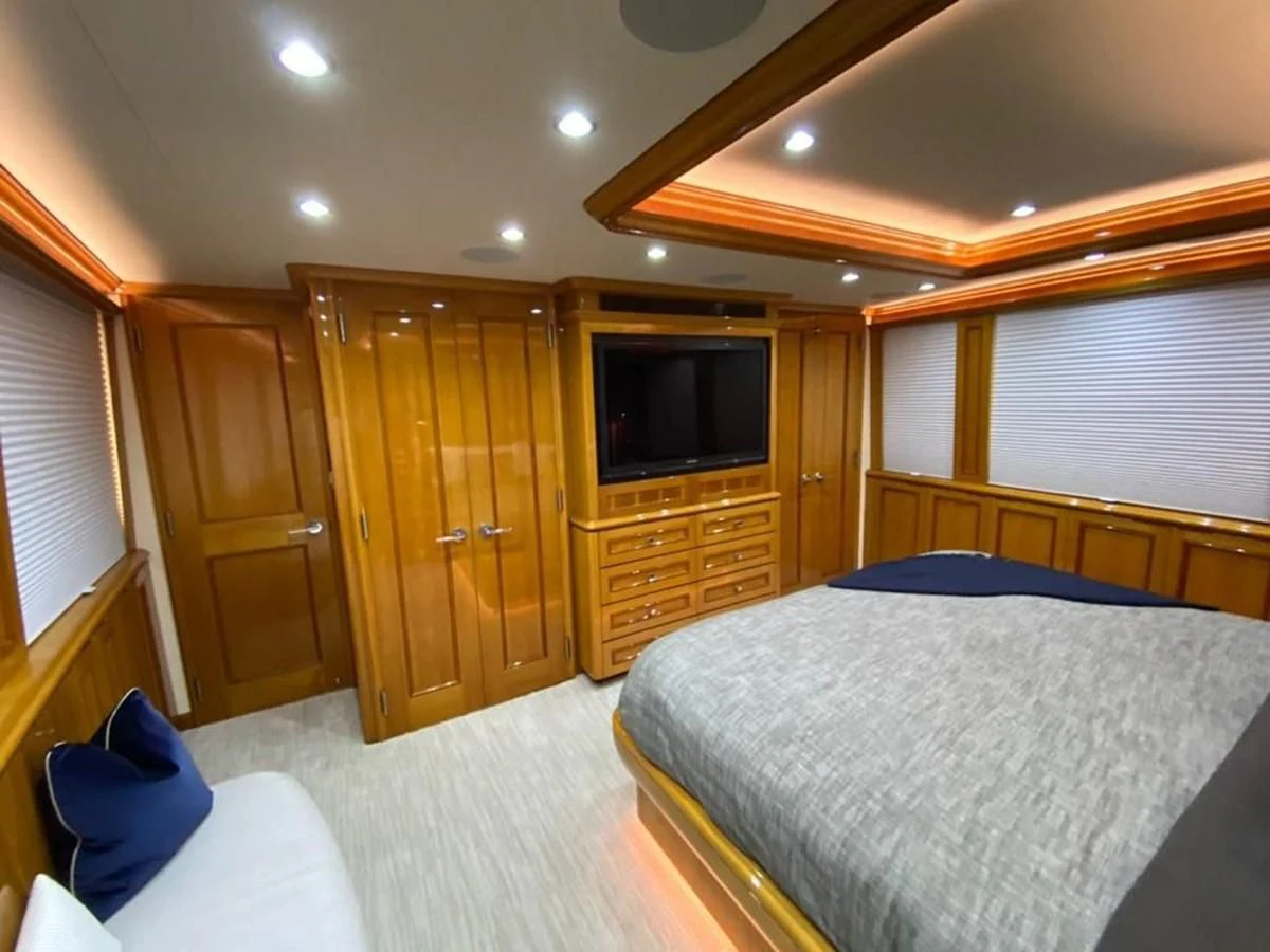 a bedroom with a bed and a television aboard BLUE STEELE Yacht for Sale