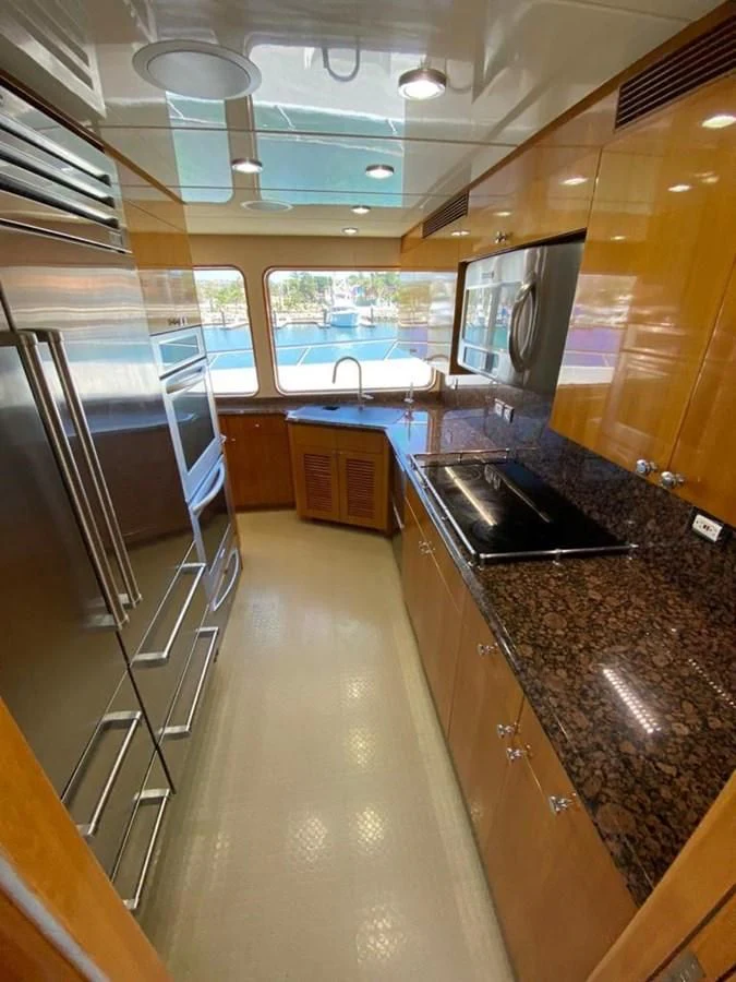 a kitchen with a large stainless steel stove and a large island aboard BLUE STEELE Yacht for Sale