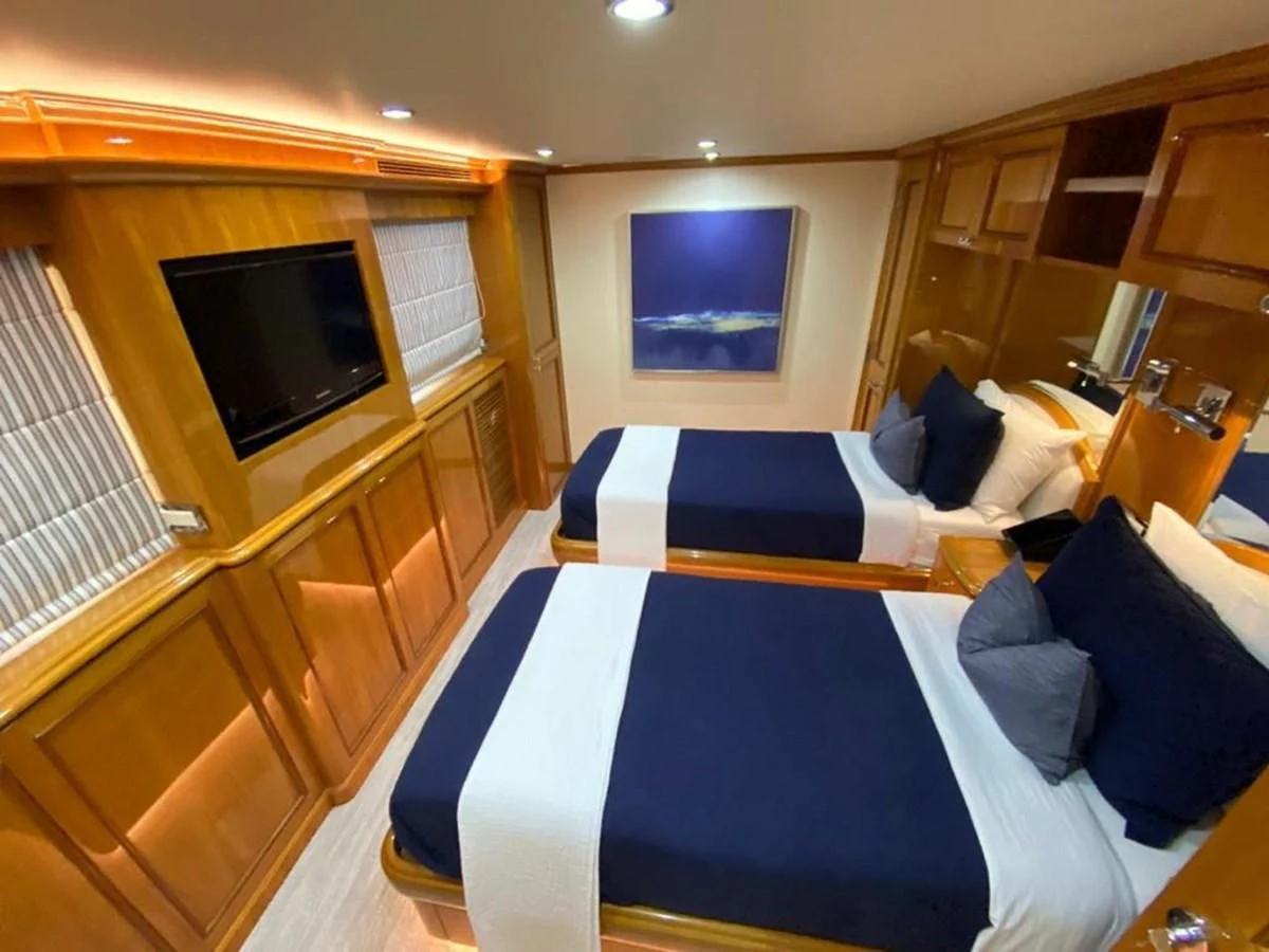 a bedroom with a bed and a television aboard BLUE STEELE Yacht for Sale
