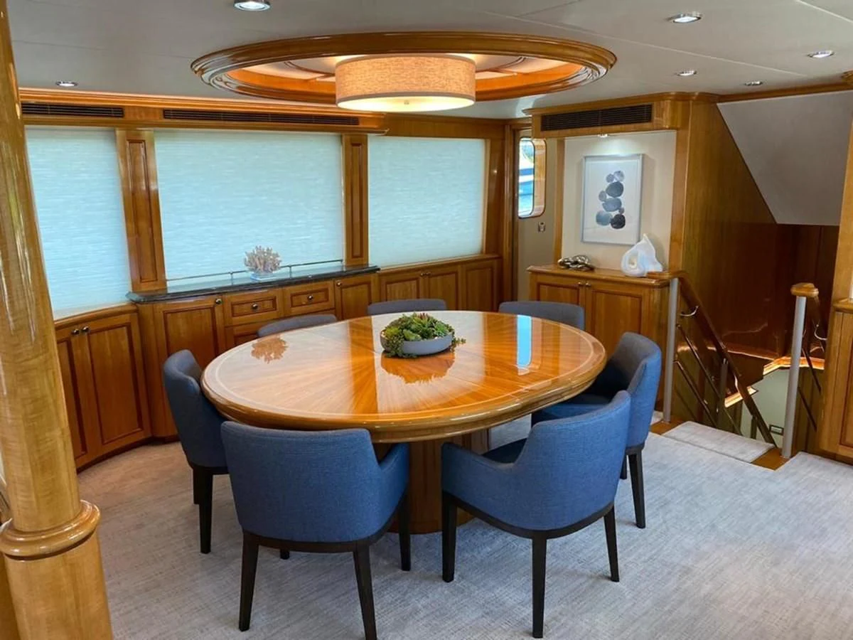 a dining table and chairs in a room with a window aboard BLUE STEELE Yacht for Sale