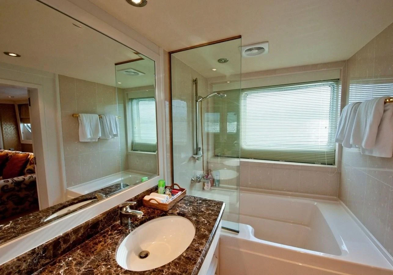 a bathroom with a large mirror aboard LANGKAWI LADY Yacht for Sale