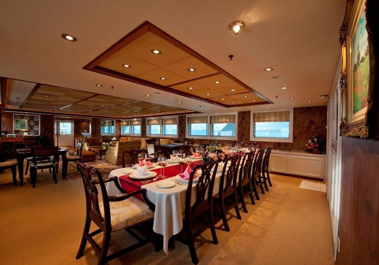 a dining room with a table and chairs aboard LANGKAWI LADY Yacht for Sale
