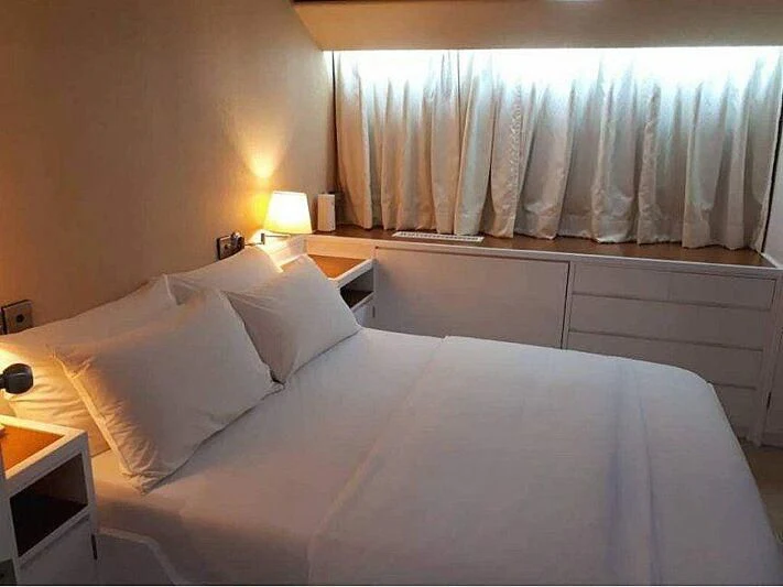 a bed with white sheets aboard LANGKAWI LADY Yacht for Sale