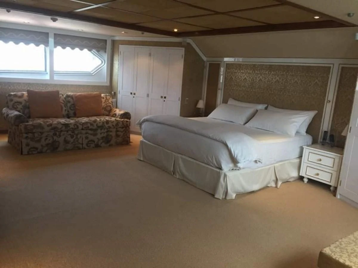 a large bedroom with a bed aboard LANGKAWI LADY Yacht for Sale