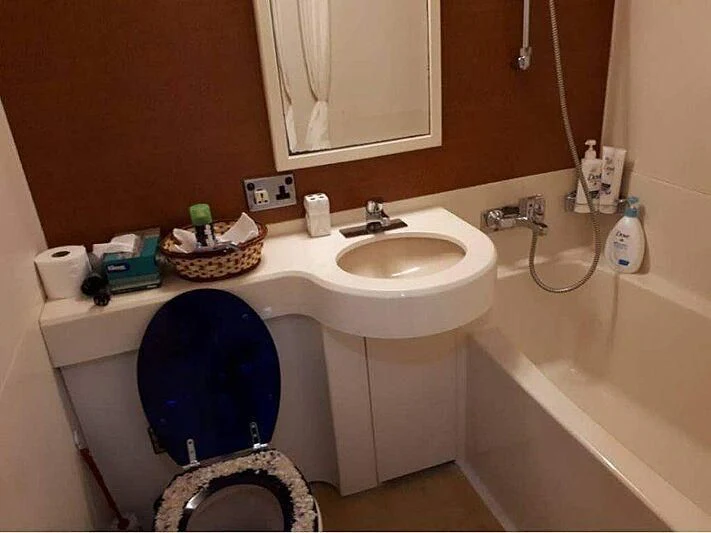 a bathroom with a blue toilet aboard LANGKAWI LADY Yacht for Sale