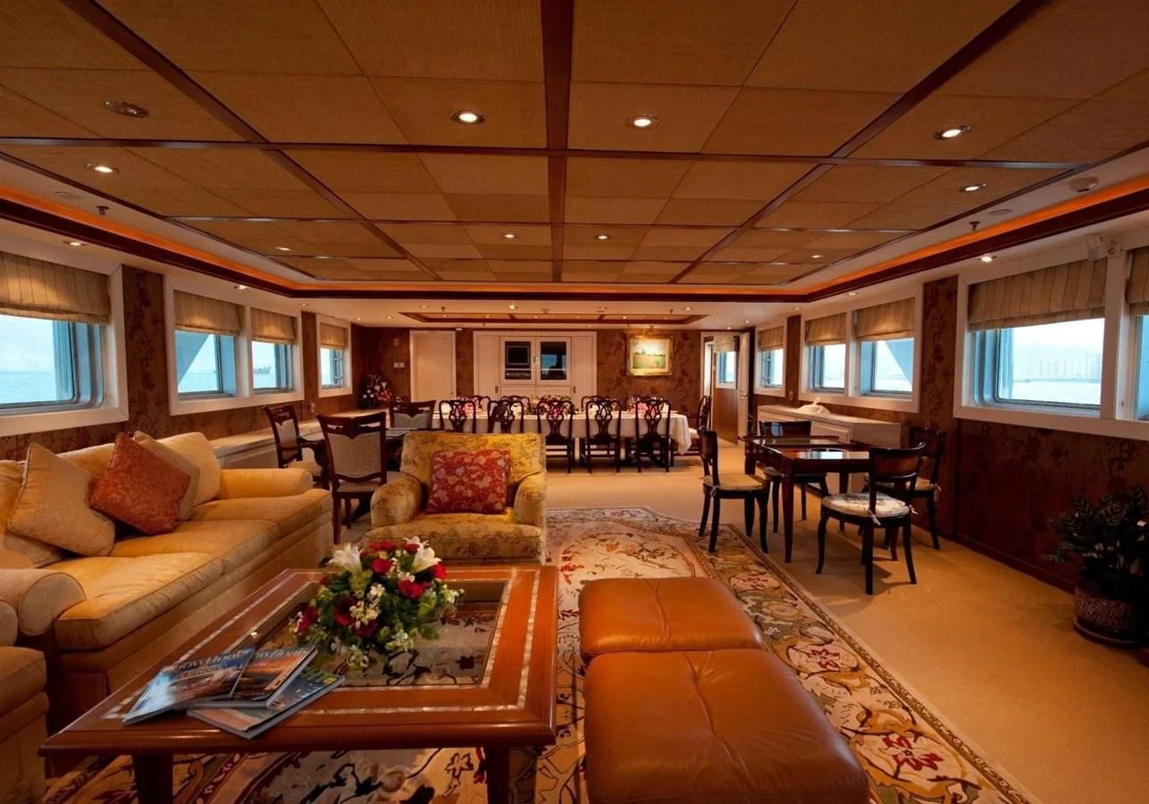 a living room with a couch and a coffee table aboard LANGKAWI LADY Yacht for Sale