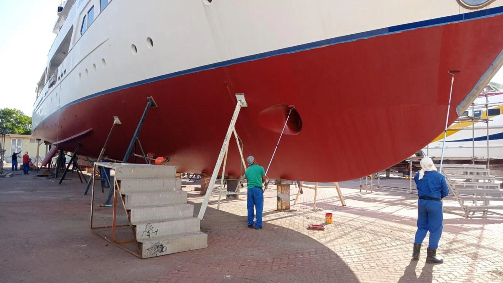 a person standing next to a large red and white plane aboard LANGKAWI LADY Yacht for Sale