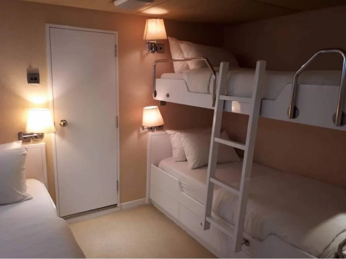 a room with a bed and a door aboard LANGKAWI LADY Yacht for Sale