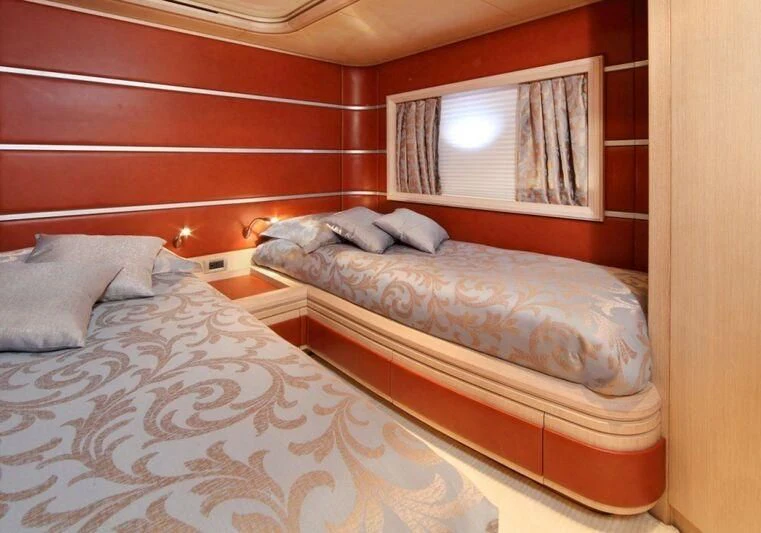 a couple of beds in a room aboard SKAZKA Yacht for Sale