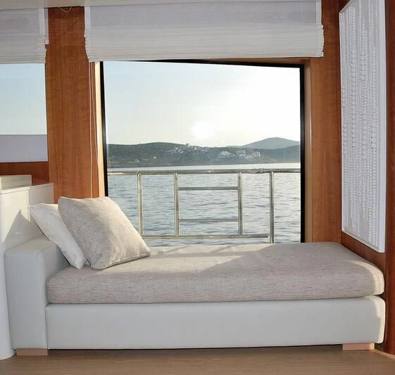 a bed with a window aboard FUNSEA Yacht for Sale