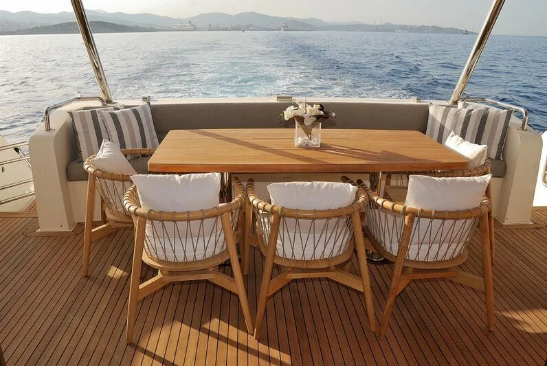 a table and chairs on a deck aboard FUNSEA Yacht for Sale
