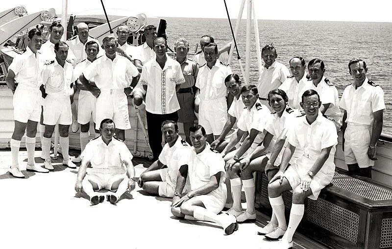 a group of people posing for a photo on a boat aboard BRITANNIA Yacht for Sale
