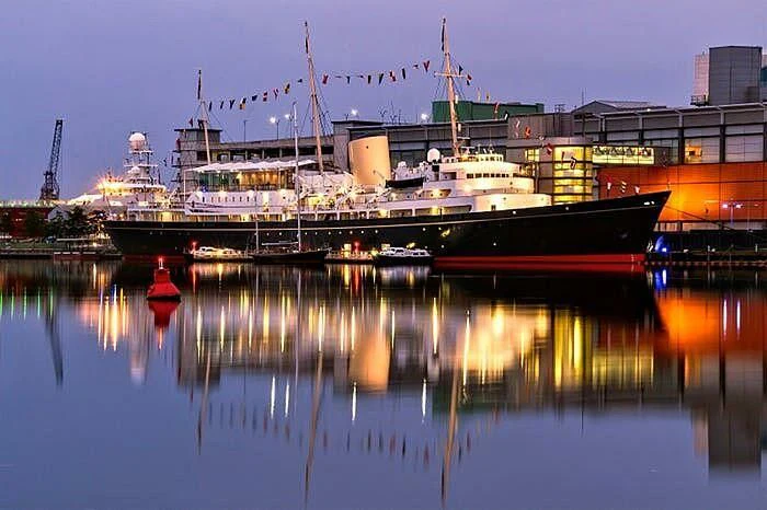 a large ship docked at a harbor aboard BRITANNIA Yacht for Sale