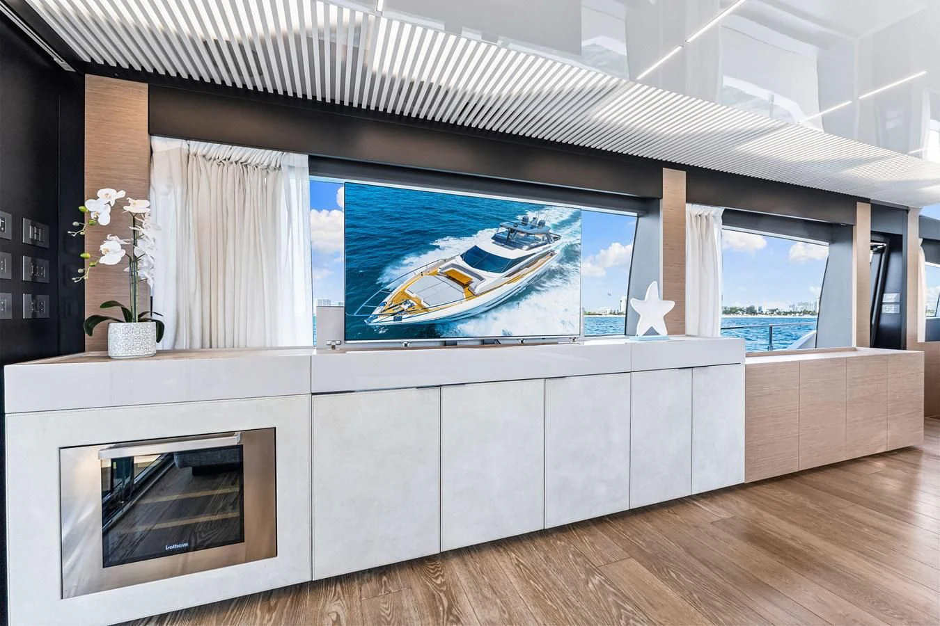 a room with a fireplace and a large screen aboard SUNSATION Yacht for Sale