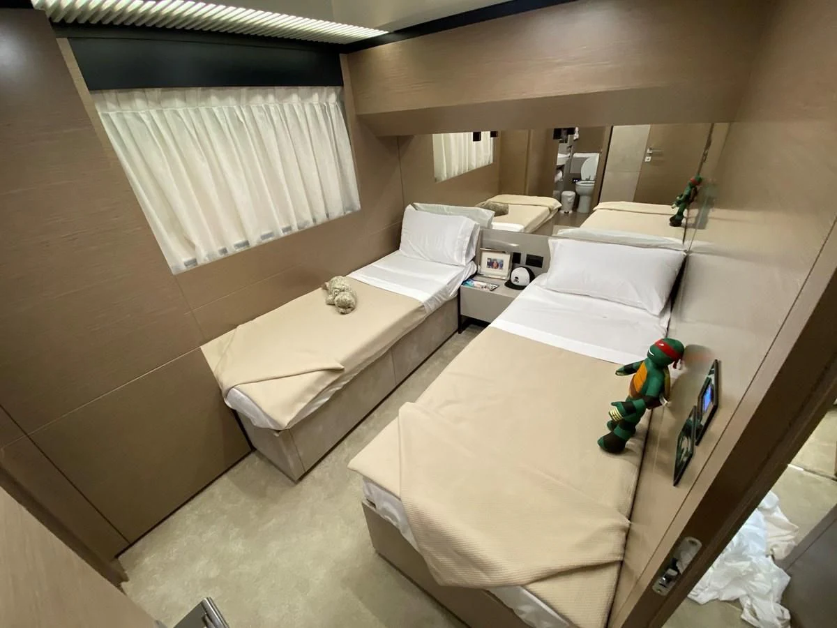 a room with a bed and a desk aboard SUNSATION Yacht for Sale