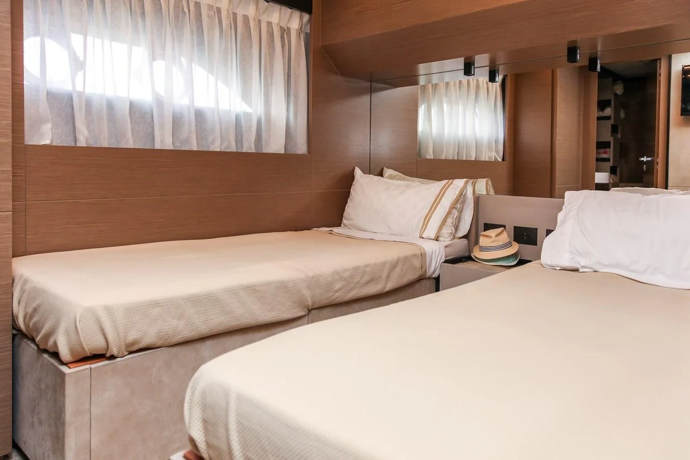 a couple of beds in a hotel room aboard SUNSATION Yacht for Sale