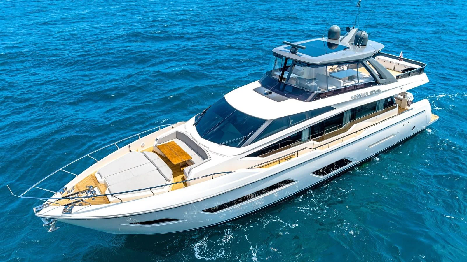 a white yacht in the water aboard SUNSATION Yacht for Sale