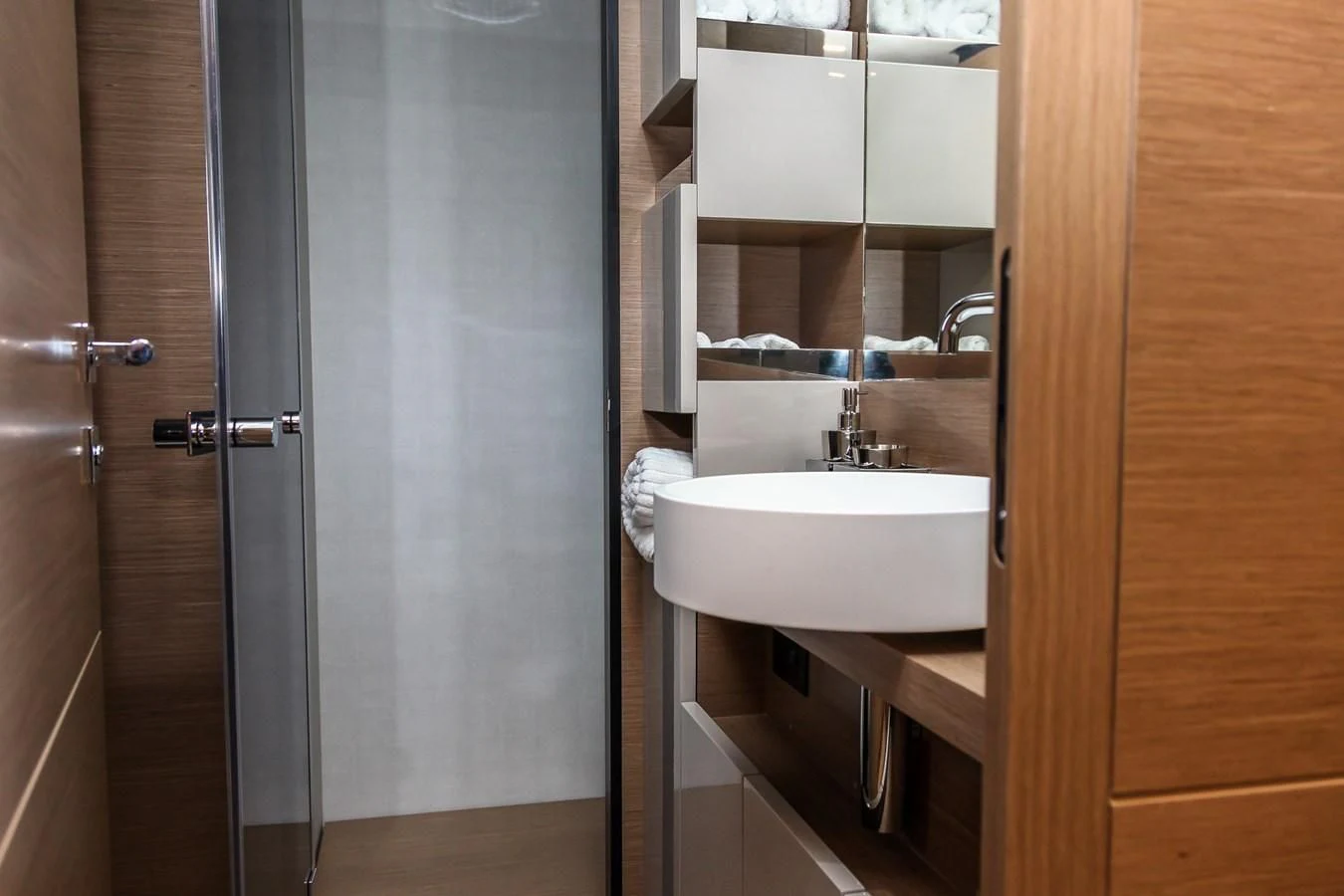 a bathroom with a sink and a shower aboard SUNSATION Yacht for Sale