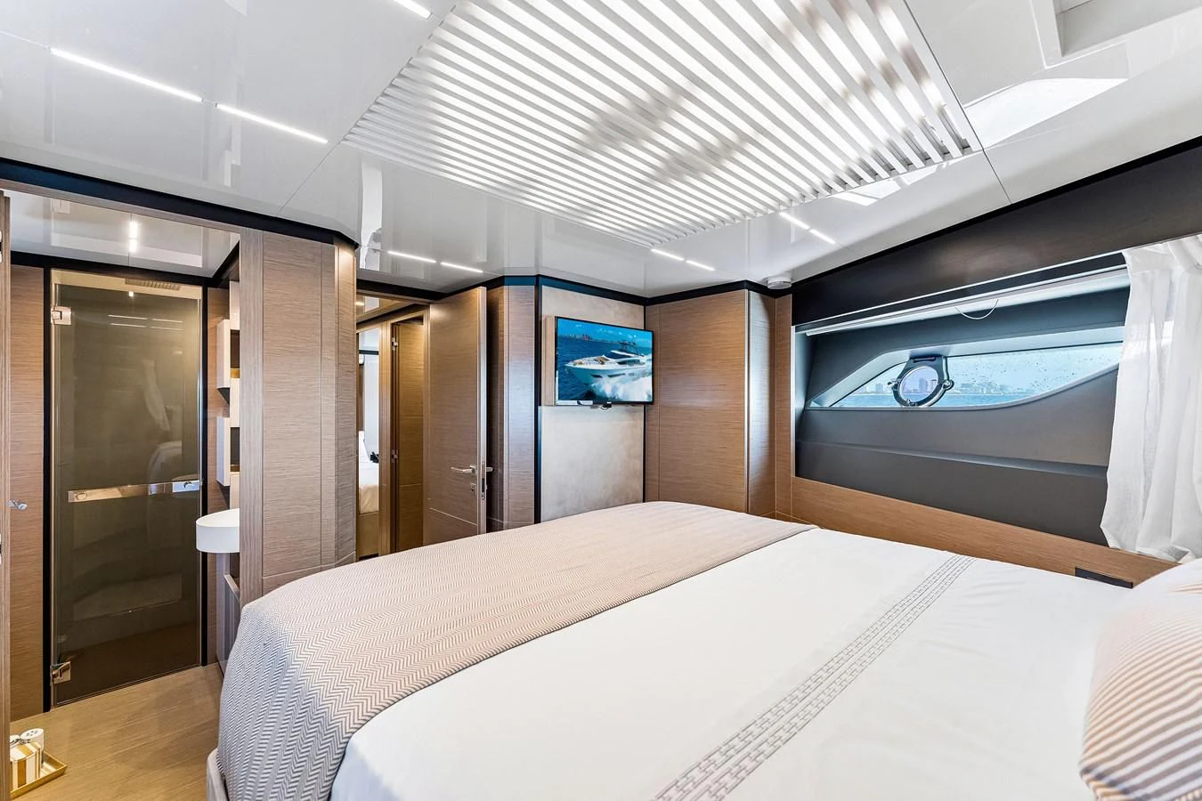 a room with a bed and a tv on the wall aboard SUNSATION Yacht for Sale