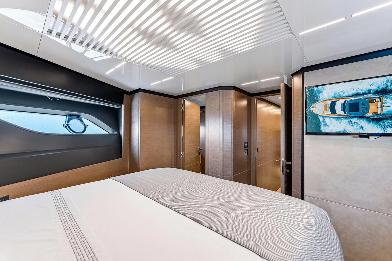 a room with a bed and a television aboard SUNSATION Yacht for Sale