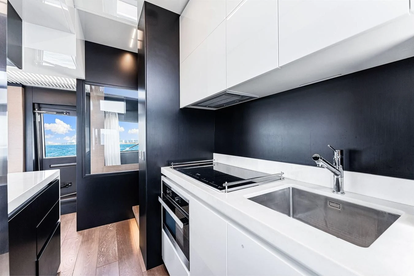 a kitchen with black and white cabinets aboard SUNSATION Yacht for Sale