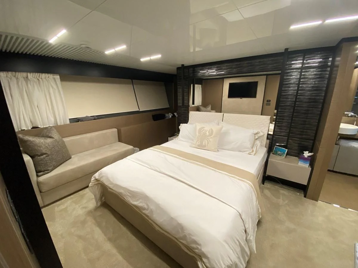 a room with a bed and a couch aboard SUNSATION Yacht for Sale