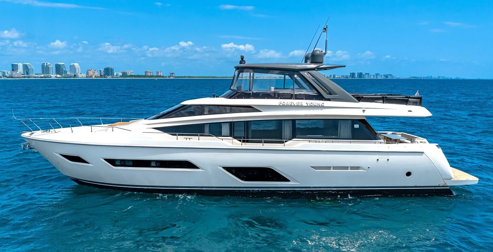 a white yacht in the water aboard SUNSATION Yacht for Sale