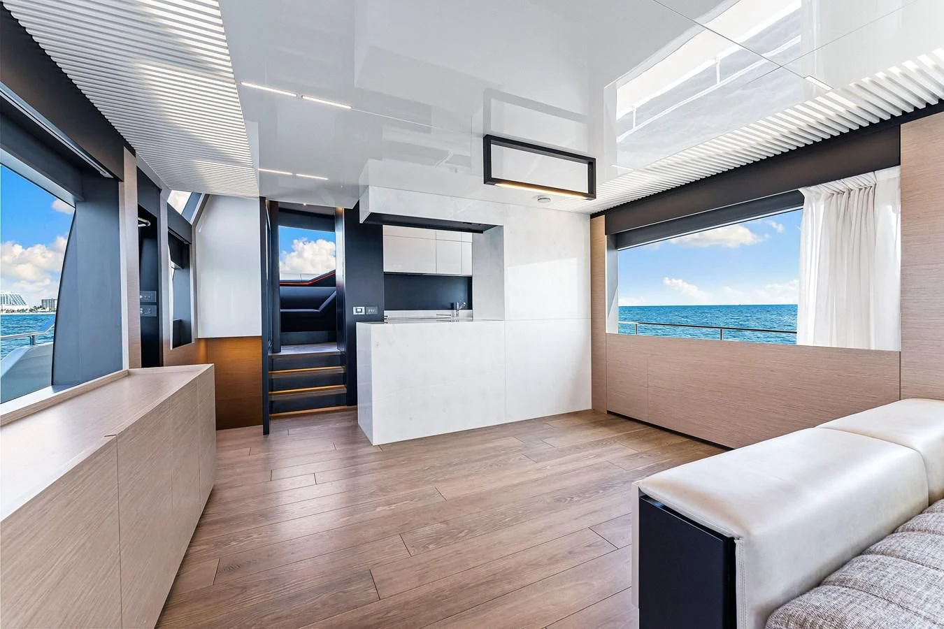 a room with a large window and a wood floor aboard SUNSATION Yacht for Sale
