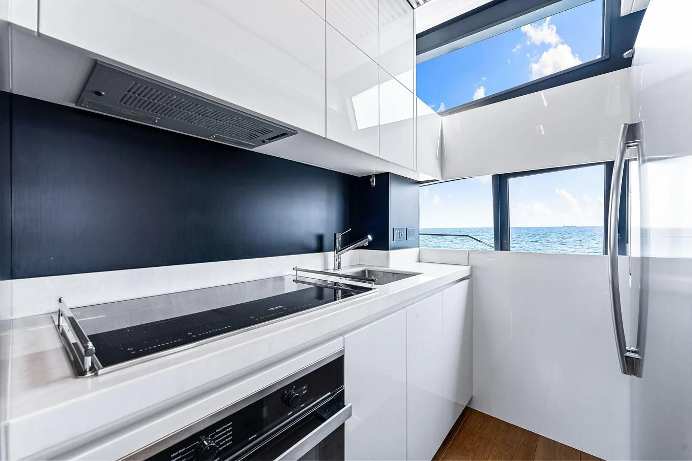 a kitchen with a large window aboard SUNSATION Yacht for Sale