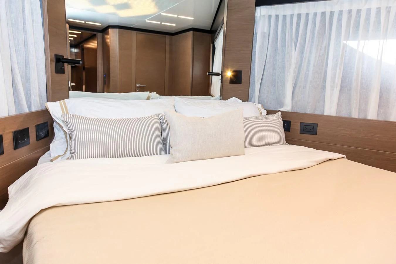 a bed with white sheets aboard SUNSATION Yacht for Sale