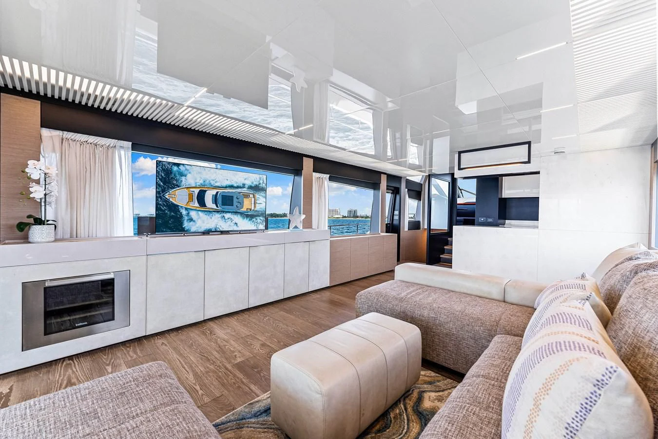 a living room with a large screen aboard SUNSATION Yacht for Sale