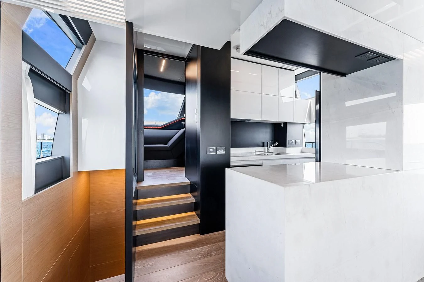 a modern kitchen with a black staircase aboard SUNSATION Yacht for Sale