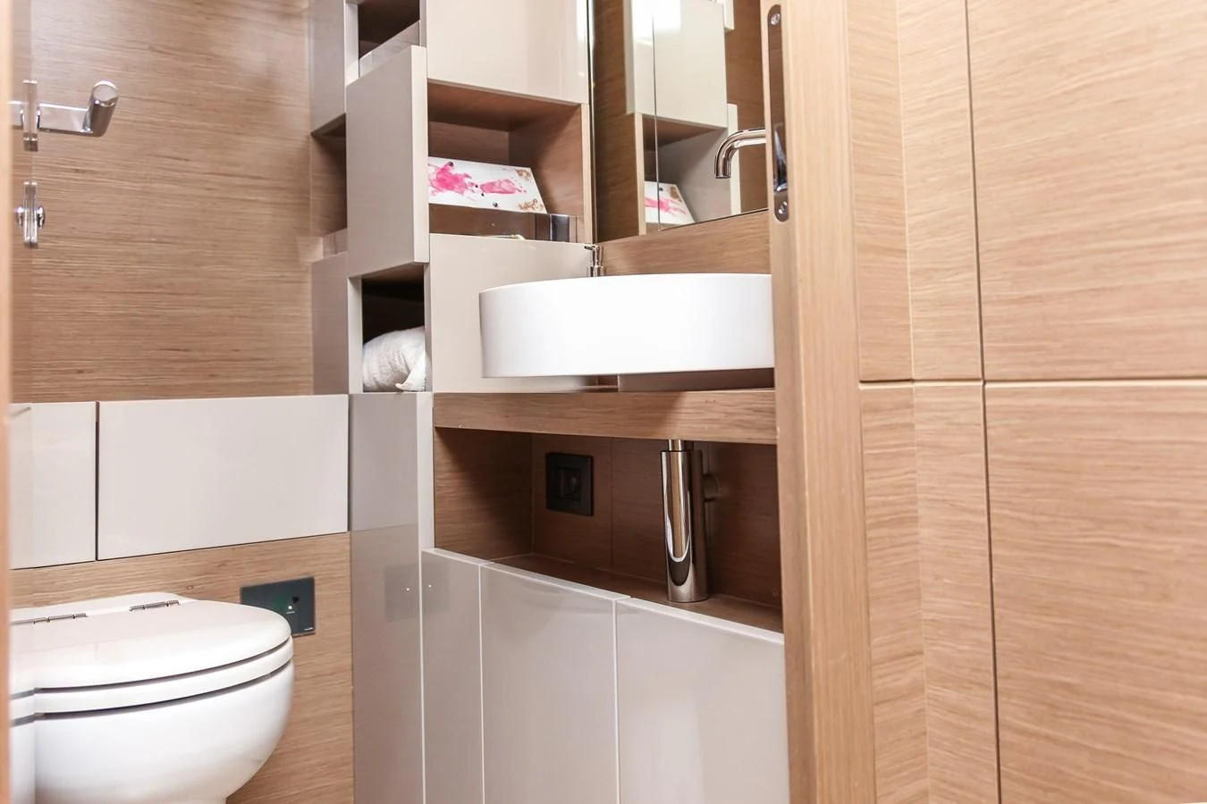a bathroom with a toilet and sink aboard SUNSATION Yacht for Sale